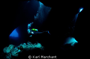 Divers enter 'Swiss Cheese' Dive site in Menorca by Karl Marchant 
